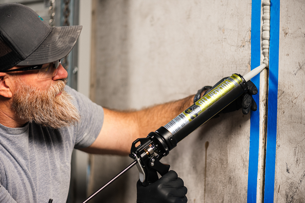 Installer applies sealant on concrete