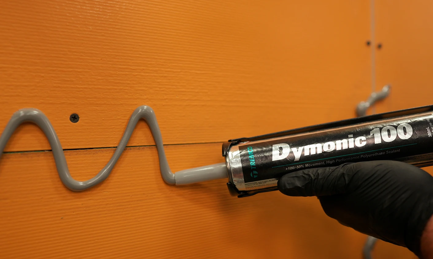 Dymonic 100 urethane sealant on sheathing.